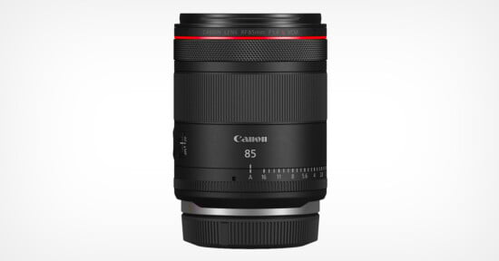 A Canon RF 85mm F1.4 L lens in black, standing vertically against a plain white background. The lens features a red ring near the top and clearly marked focus and aperture settings.