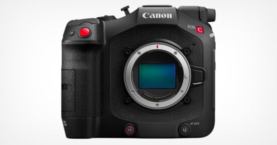 Front view of a Canon EOS C70 cinema camera with a large sensor opening in the center. The camera has several buttons, dials, and a textured grip on the left side with a prominent red record button. The Canon logo and camera model name are displayed at the top.