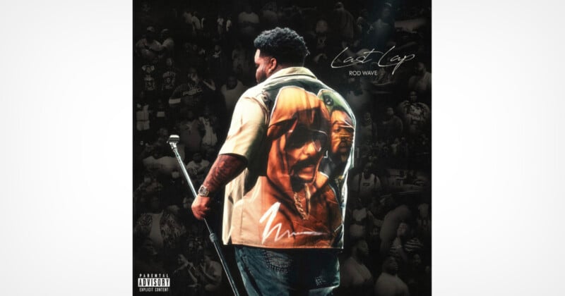 A man stands on stage holding a microphone, wearing a shirt with a large image of a person's face on the back. The background shows a crowd in grayscale. Text reads "Nostalgia Rod Wave.