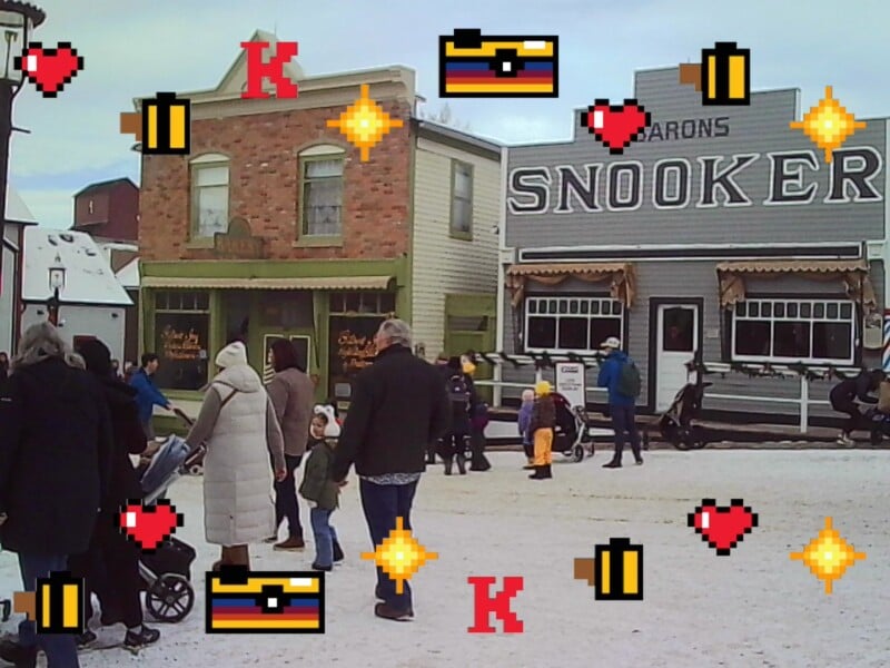 People walk on a snowy street in front of vintage-style buildings, with pixelated icons of hearts, cameras, coins, and stars digitally overlaid on the image.