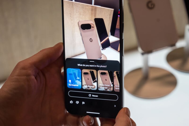 A person holds a smartphone displaying a camera app focused on Google Pixel phones, with the screen showing object recognition options for the phone in view.