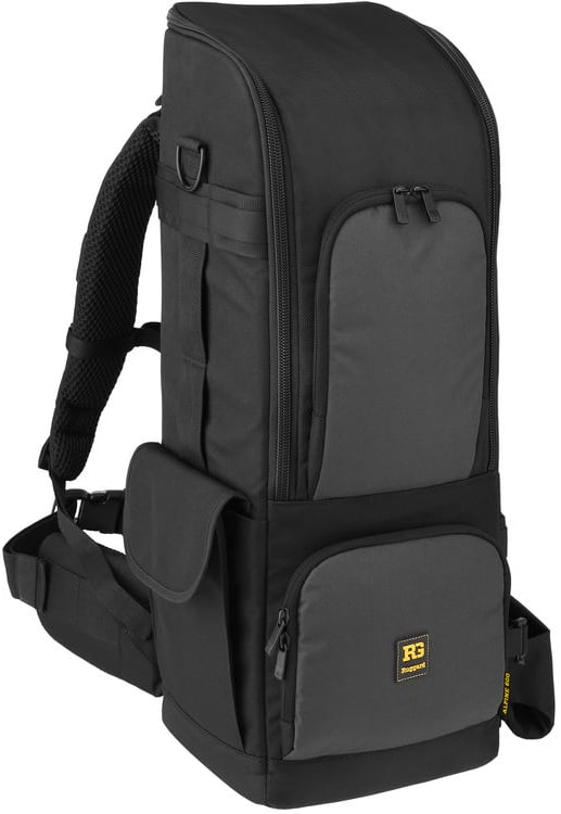 A tall, black backpack with multiple zippered compartments, padded shoulder straps, a side pocket, and a small yellow logo patch on the front lower pocket.