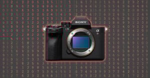 A Sony Alpha camera with its lens removed is centered against a dark background filled with red and white numbers arranged in rows and columns.