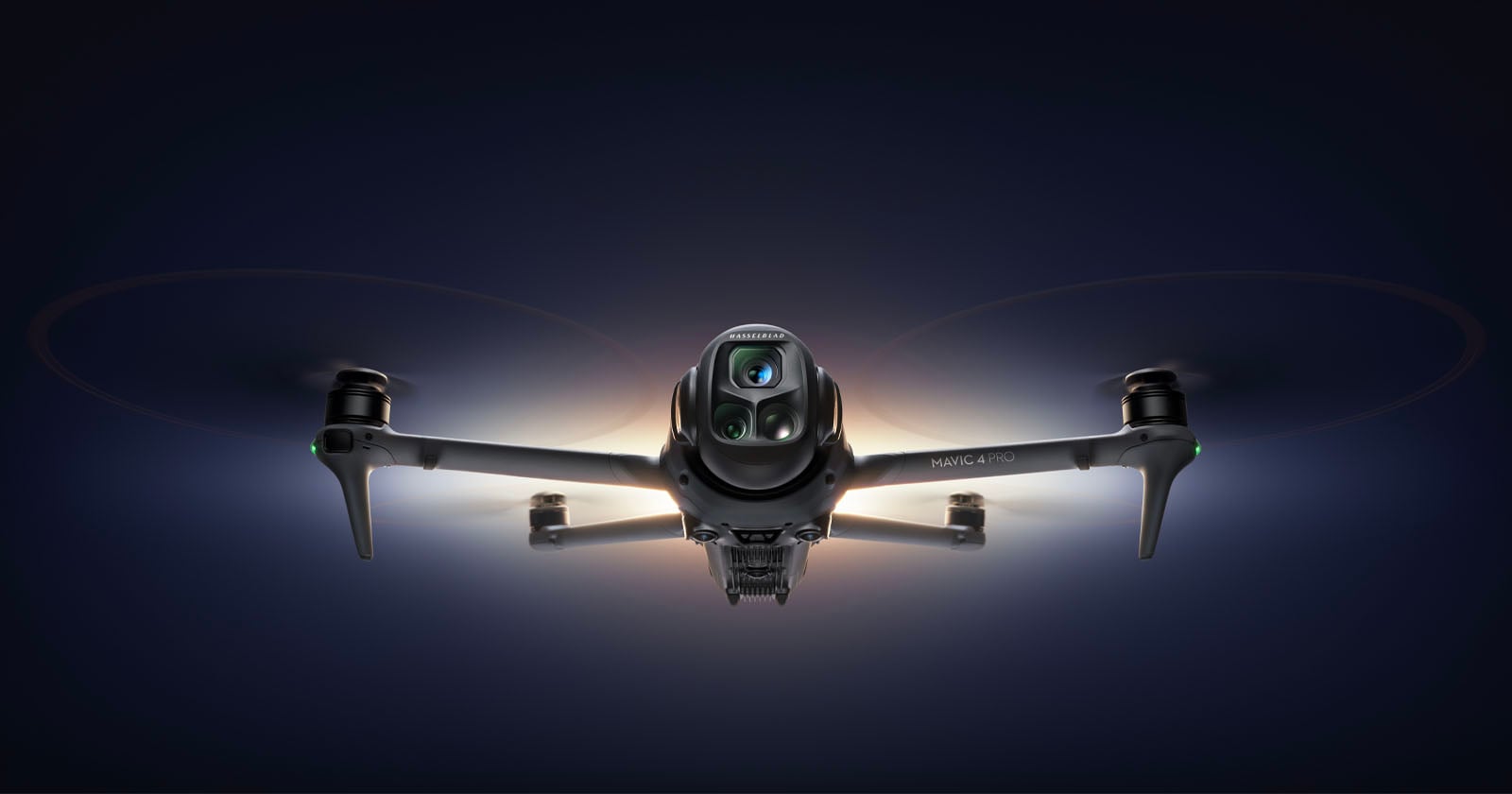 A front-facing view of a quadcopter drone, the DJI Mavic 3 Pro, with glowing lights highlighting its camera and rotors, set against a dark background.