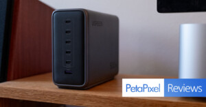 A UGREEN charging station with multiple USB-C and one USB-A port sits on a wooden shelf. The Petapixel Reviews logo appears in the bottom right corner.