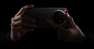 A person holds a Xiaomi smartphone with a large Leica-branded camera module, highlighted against a dark background.